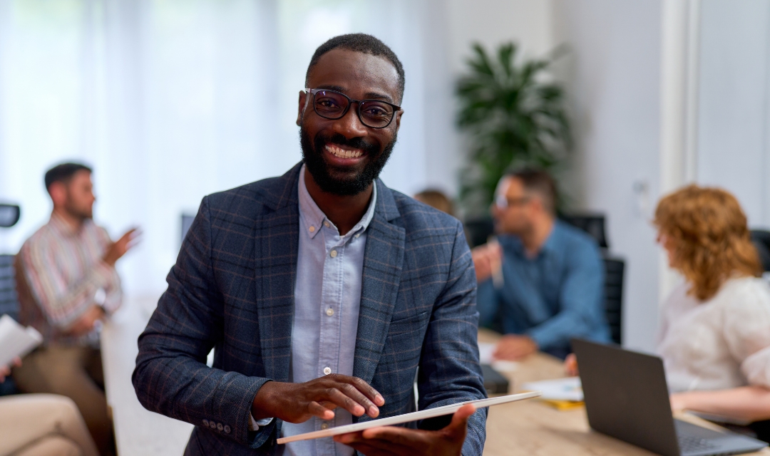 AI data analyst at a meeting with with colleagues holding a tablet